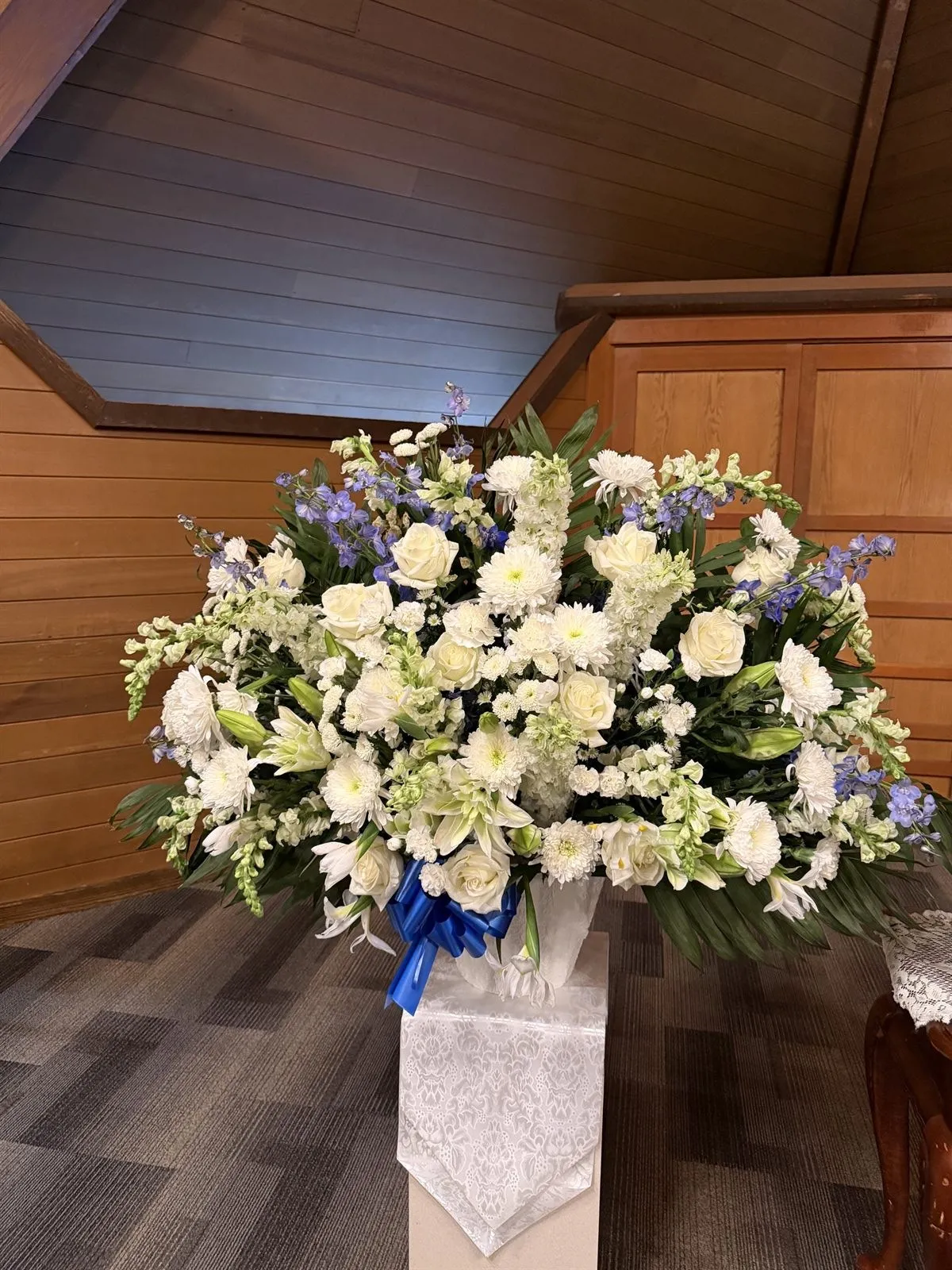 White and blue memorial arrangement at a church service in Vancouver WA