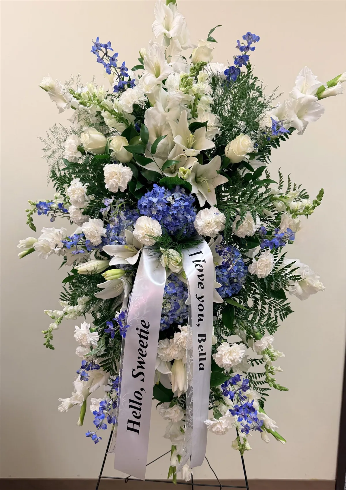 Blue and white standing spray with gladiolus, lilies, and hydrangea