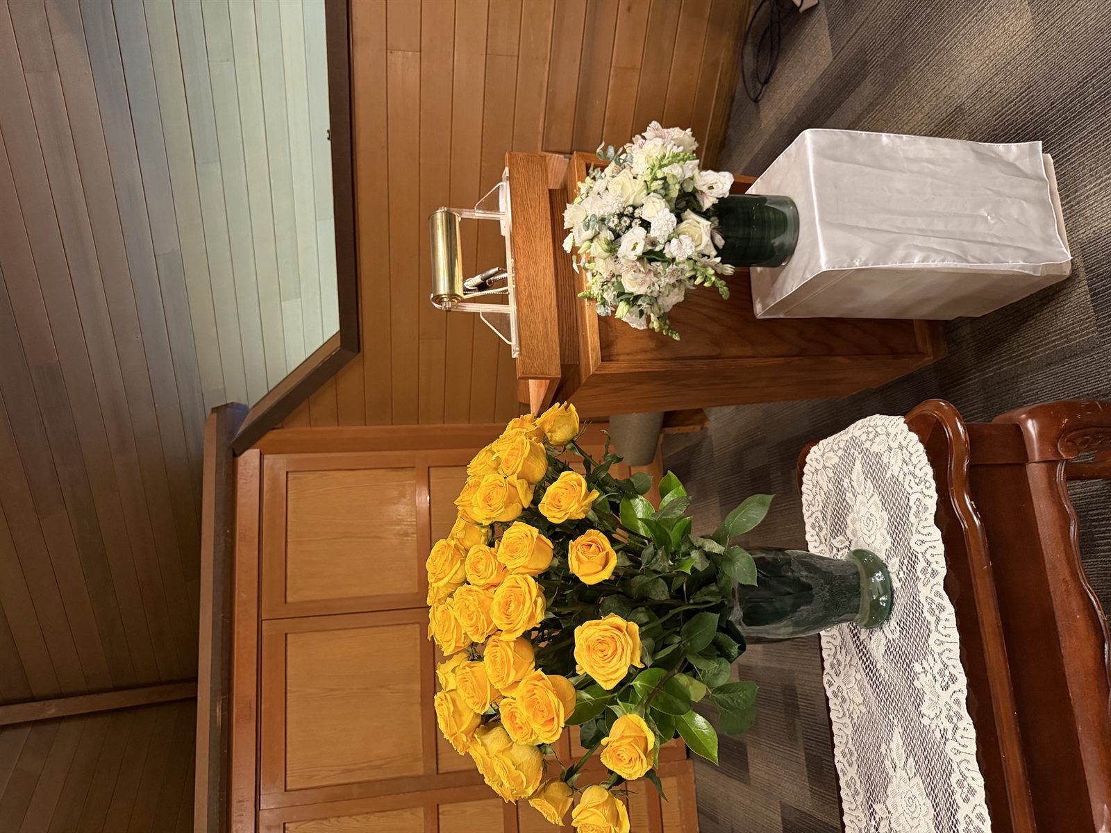 Yellow roses and white arrangement set up at a funeral service Clark County WA