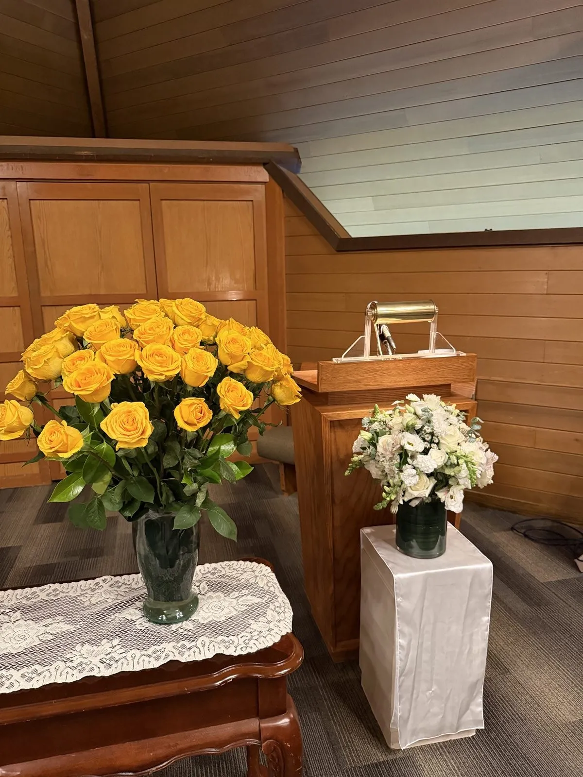 Yellow and white venue floral setup at a Clark County funeral service