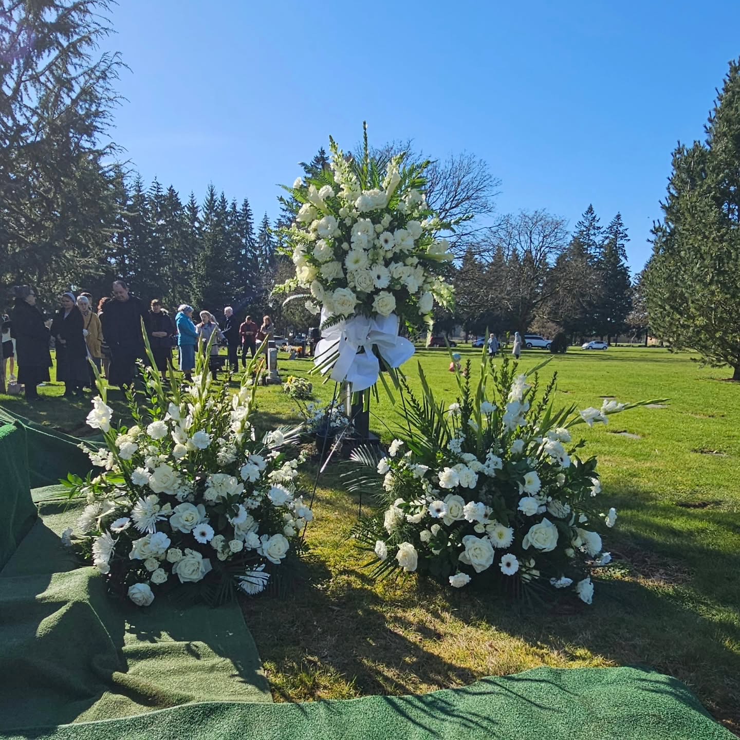 Memorial casket spray with seasonal flowers